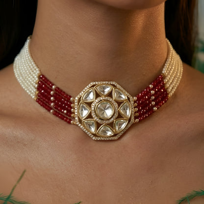 Handcrafted Kundan bracelet with red crystal bead strands and matching round stud earrings on a white background.