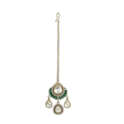 Gold-toned Kundan teardrop maang tikka with green stone detailing and three dangling teardrop charms for bridal and festive wear.