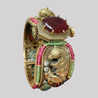 Antique gold-plated lion motif bangle with ruby centerpiece and colorful gemstones