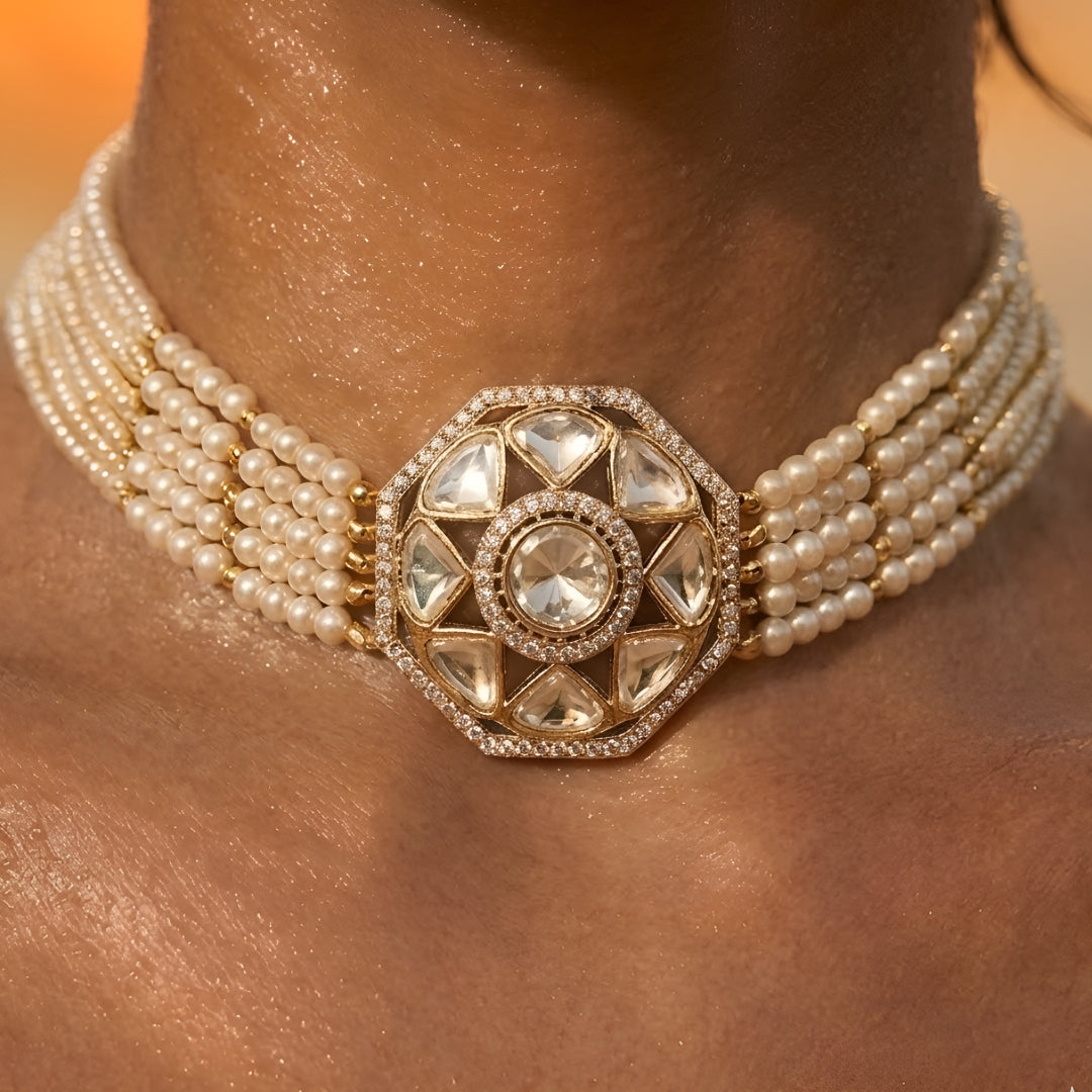 Traditional Kundan pearl choker necklace set with gold-tone finish, multi-strand pearls, and matching stud earrings for bridal and wedding wear.