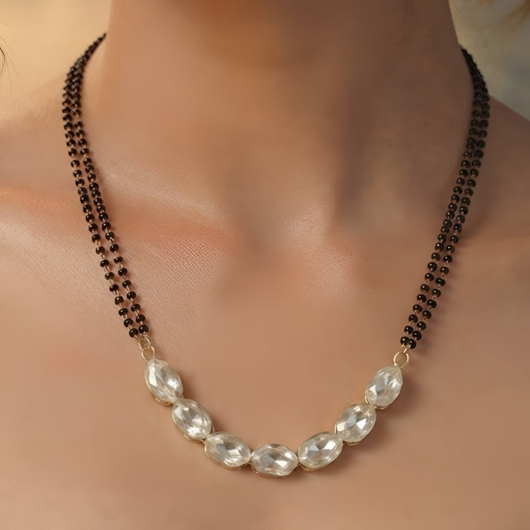 Elegant oval stone black beads mangalsutra necklace set with matching stud earrings for women in gold-tone finish