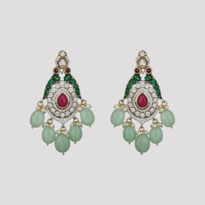 "Triple-layer gold-finish necklace set with ruby stones, green accents, AD detailing, pastel green bead drops, and matching earrings displayed on a light background."