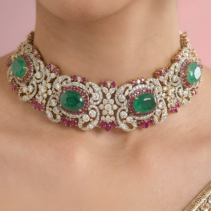 Luxury emerald green kundan choker necklace set with sparkling polki stones, ruby pink accents, and matching chandelier earrings for bridal and wedding wear.