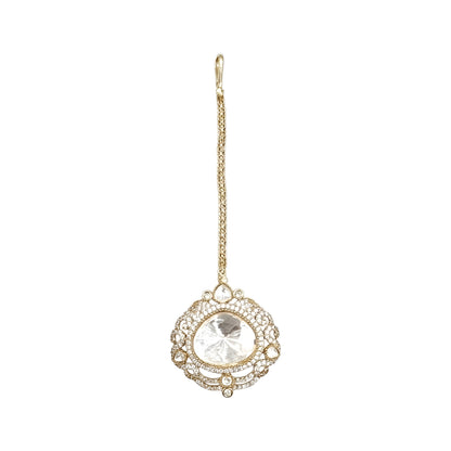 Elegant gold-tone crystal bridal maang tikka with intricate filigree design and large clear stone centerpiece for weddings and festive wear.