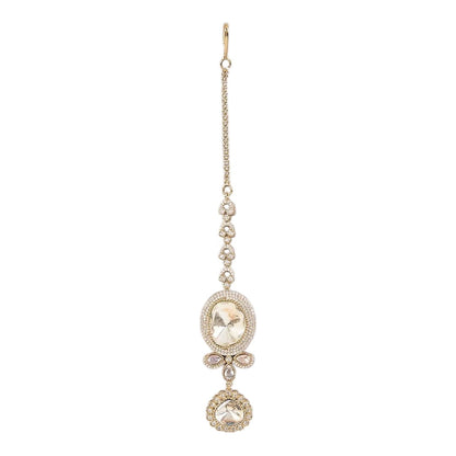 Gold-toned American Diamond oval stone maang tikka with floral crystal design and dangling charm for bridal and festive wear.