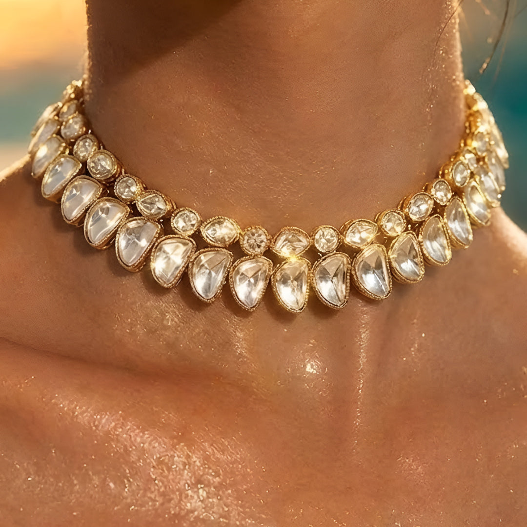 Luxury gold-tone Kundan statement necklace with clear uncut stones in an elegant crescent design for bridal and wedding jewelry.
