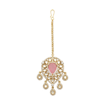 Gold-plated bridal maang tikka with pink pear-shaped stone, Kundan-style teardrop crystals, and elegant dangling accents for weddings and festive wear.