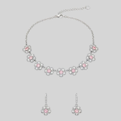 Silver floral necklace and matching earrings set with sparkling round crystals displayed on a red velvet jewelry stand, perfect for weddings and festive occasions.