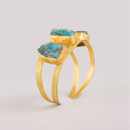 Blue stone gold tone designer cuff bangle with engraved detailing for women