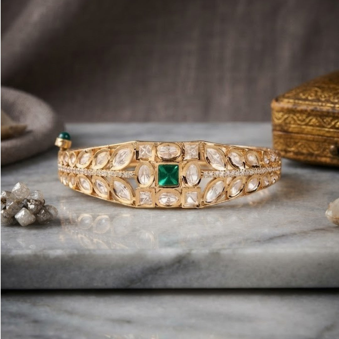 Green stone AD studded gold tone designer kada bracelet with intricate leaf detailing
