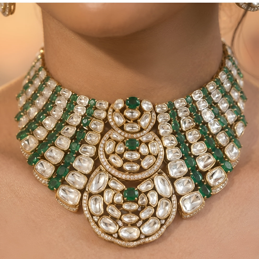 Luxury Kundan Polki necklace set with matching earrings featuring uncut Polki diamonds, green emerald accents, and traditional bridal jewelry craftsmanship in a gold finish.