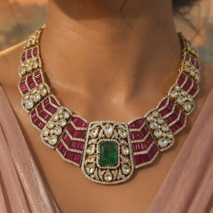 Luxury ruby and emerald CZ statement necklace set with matching earrings in gold plating, perfect for bridal, wedding, festive, and party wear.