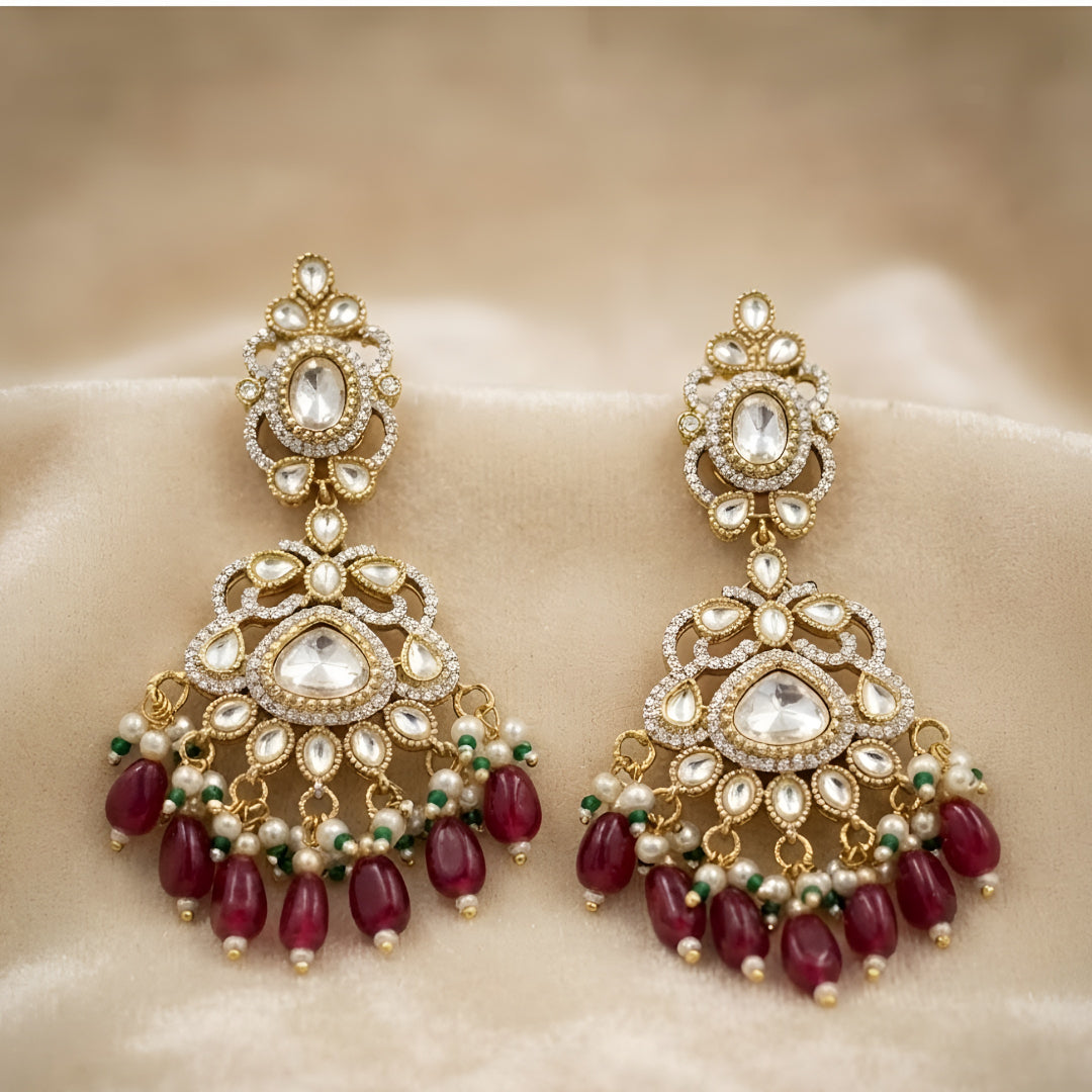 Antique gold Kundan Chandbali earrings with ruby bead drops, pearl clusters, and traditional bridal design for women.