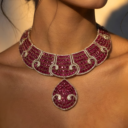 Luxury ruby pink crystal statement choker necklace set with teardrop pendant and matching earrings for weddings and festive occasions.