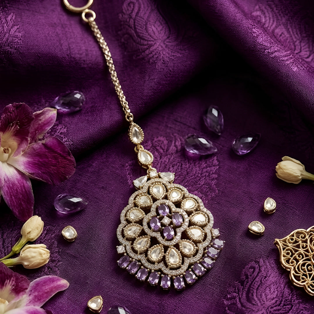 Silver-tone Kundan maang tikka with white stones and purple crystal accents, perfect for bridal, wedding, and festive wear.