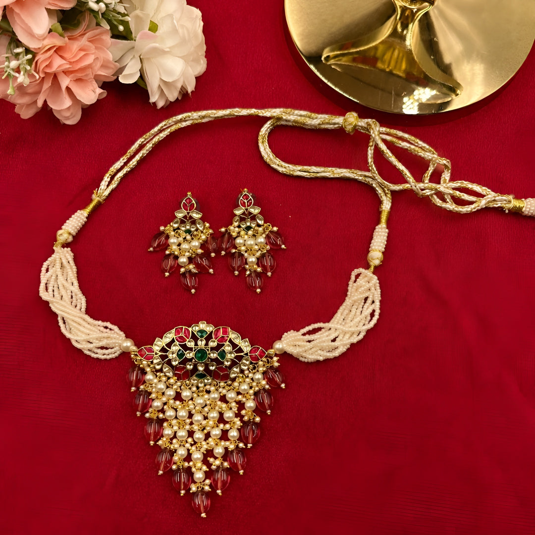 "Traditional Indian bridal jewelry set with pearl strands and maroon beaded tassels"