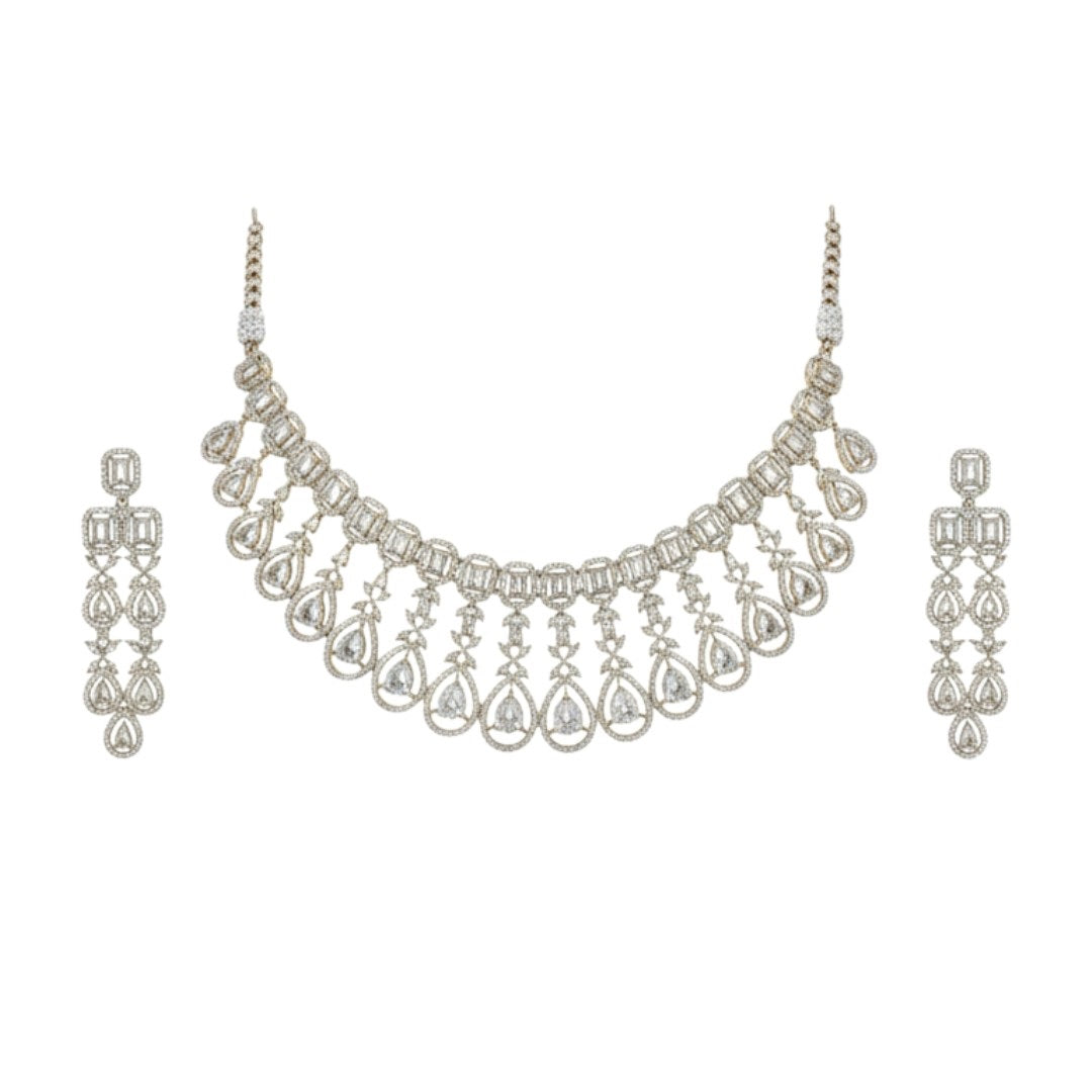 Gold plated bridal Kundan choker necklace set with teardrop earrings displayed on a red velvet stand.