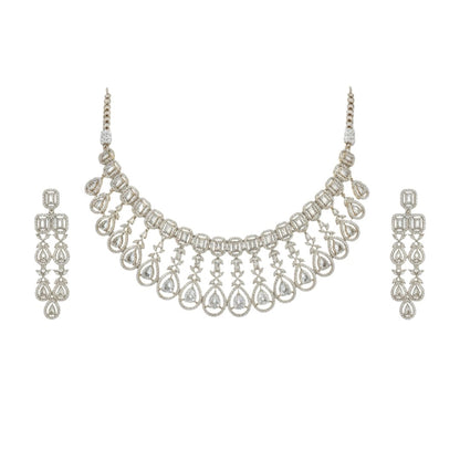 Gold plated bridal Kundan choker necklace set with teardrop earrings displayed on a red velvet stand.