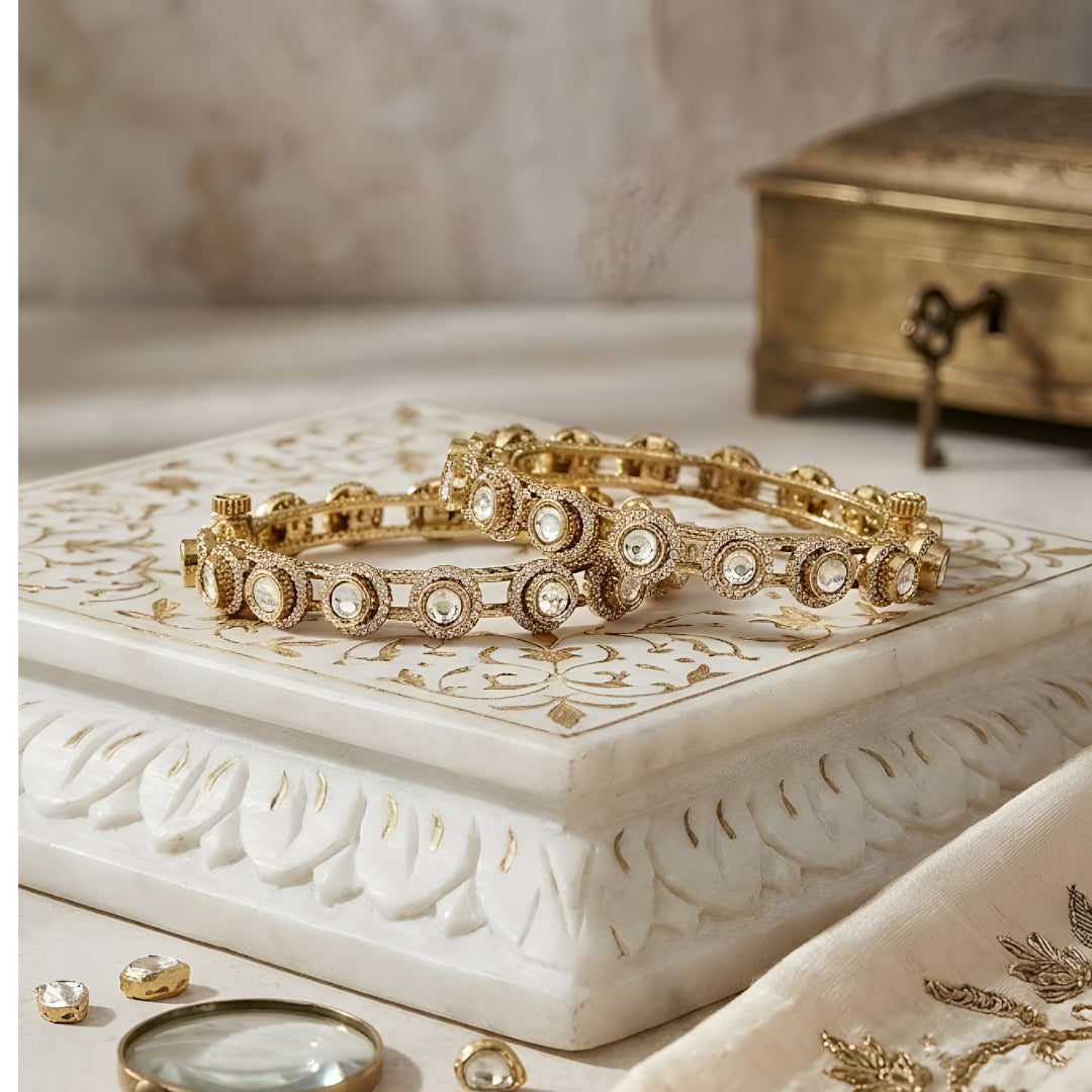 Gold-plated Kundan bangles with round white stone detailing for women, ideal for weddings and festive wear.