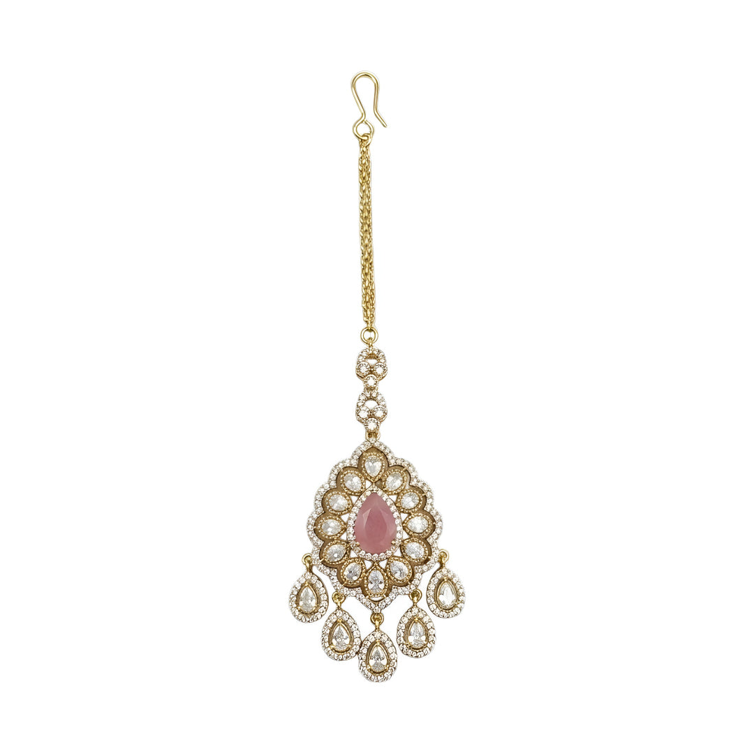 Gold plated pink stone Kundan maang tikka with Polki-inspired white stones and dangling charms for bridal wedding and festive wear.