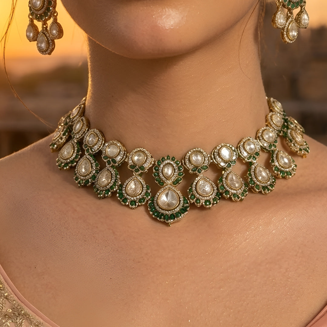 Green Kundan Polki bridal necklace set with matching earrings featuring white stones and emerald green accents in antique gold finish.