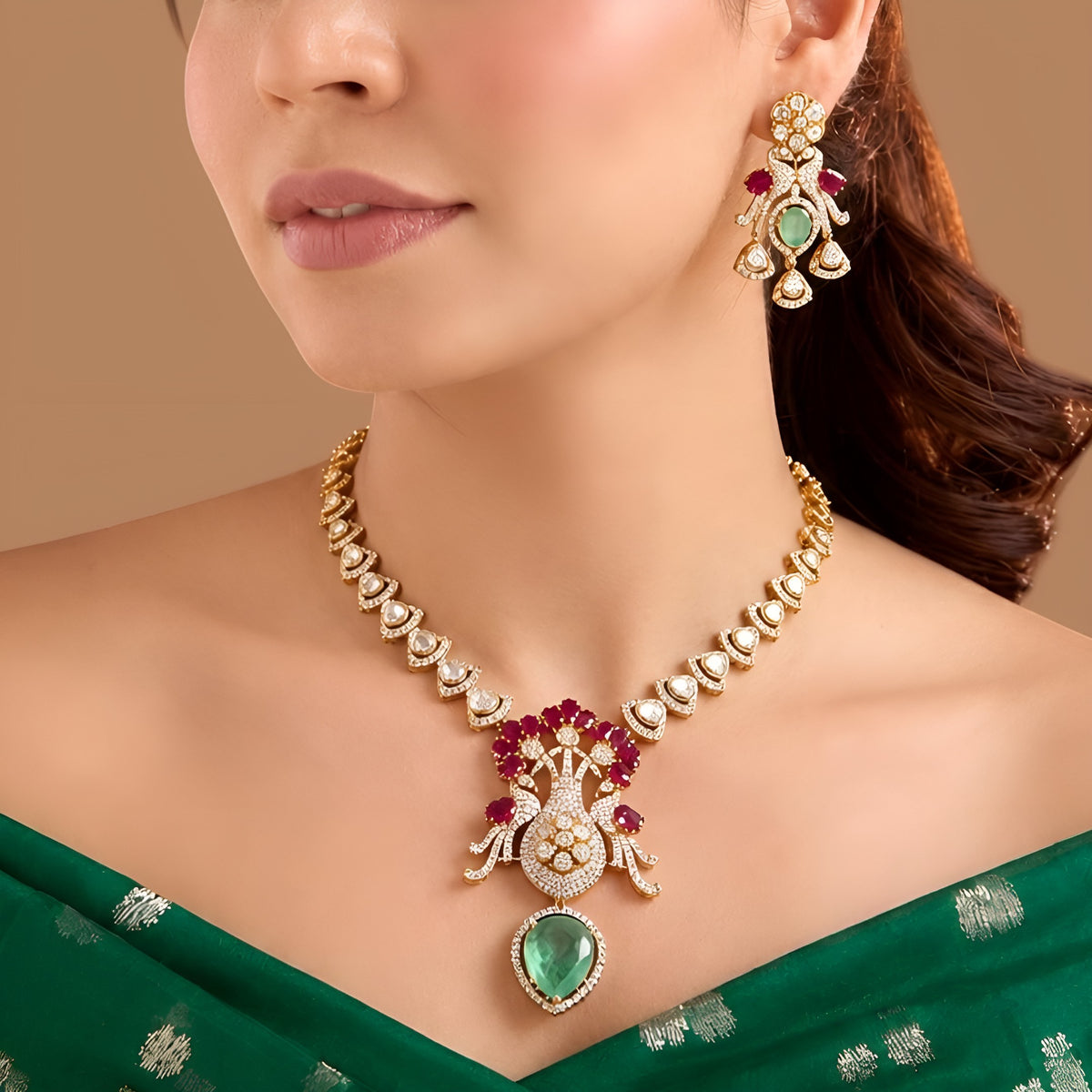 Gold-finish peacock pendant necklace set with ruby-pink stones, carved green drop and matching earrings by Auraa Trends