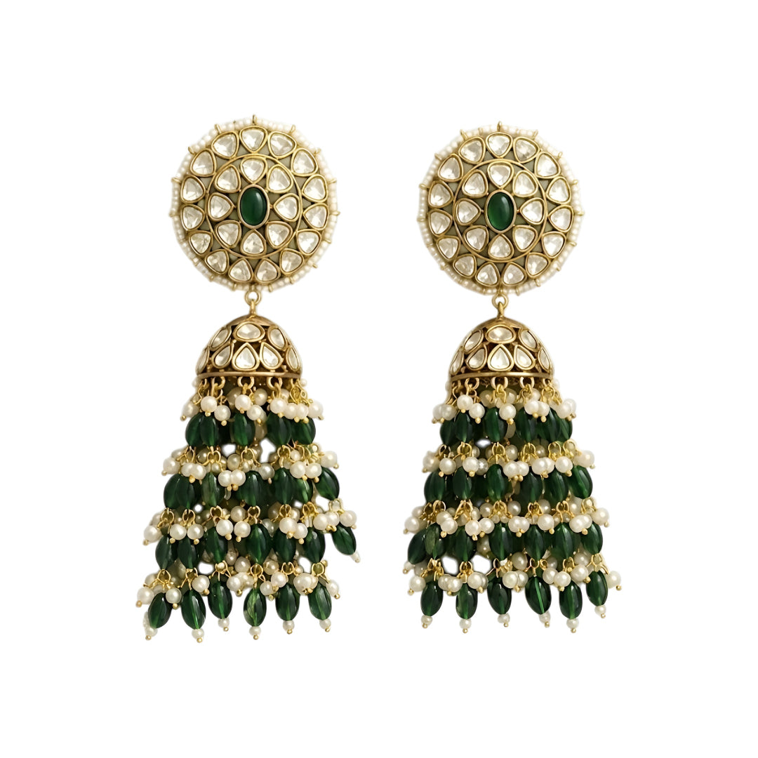 Green Kundan jhumka earrings with gold plating, emerald green center stone, pearl accents, and layered green bead tassels for bridal and festive wear.