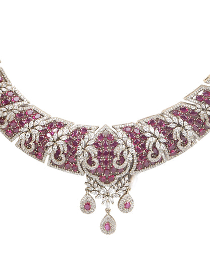 Gold-tone statement necklace set with pink ruby-style stones and clear crystals in an intricate floral design, paired with matching chandelier earrings featuring drop accents.