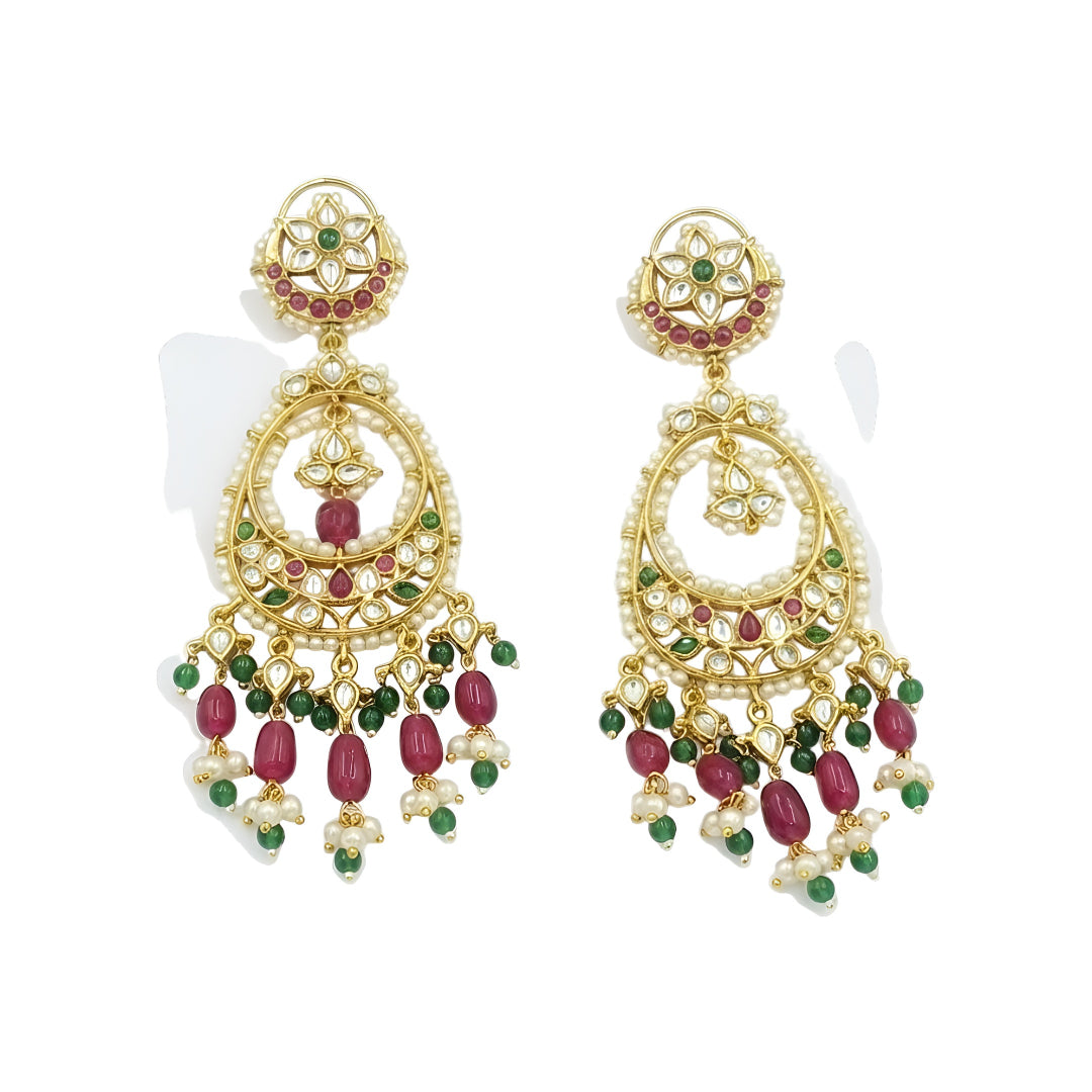 Antique gold Kundan Chandbali earrings with ruby and green stones, pearl border, and elegant bead danglers for women.