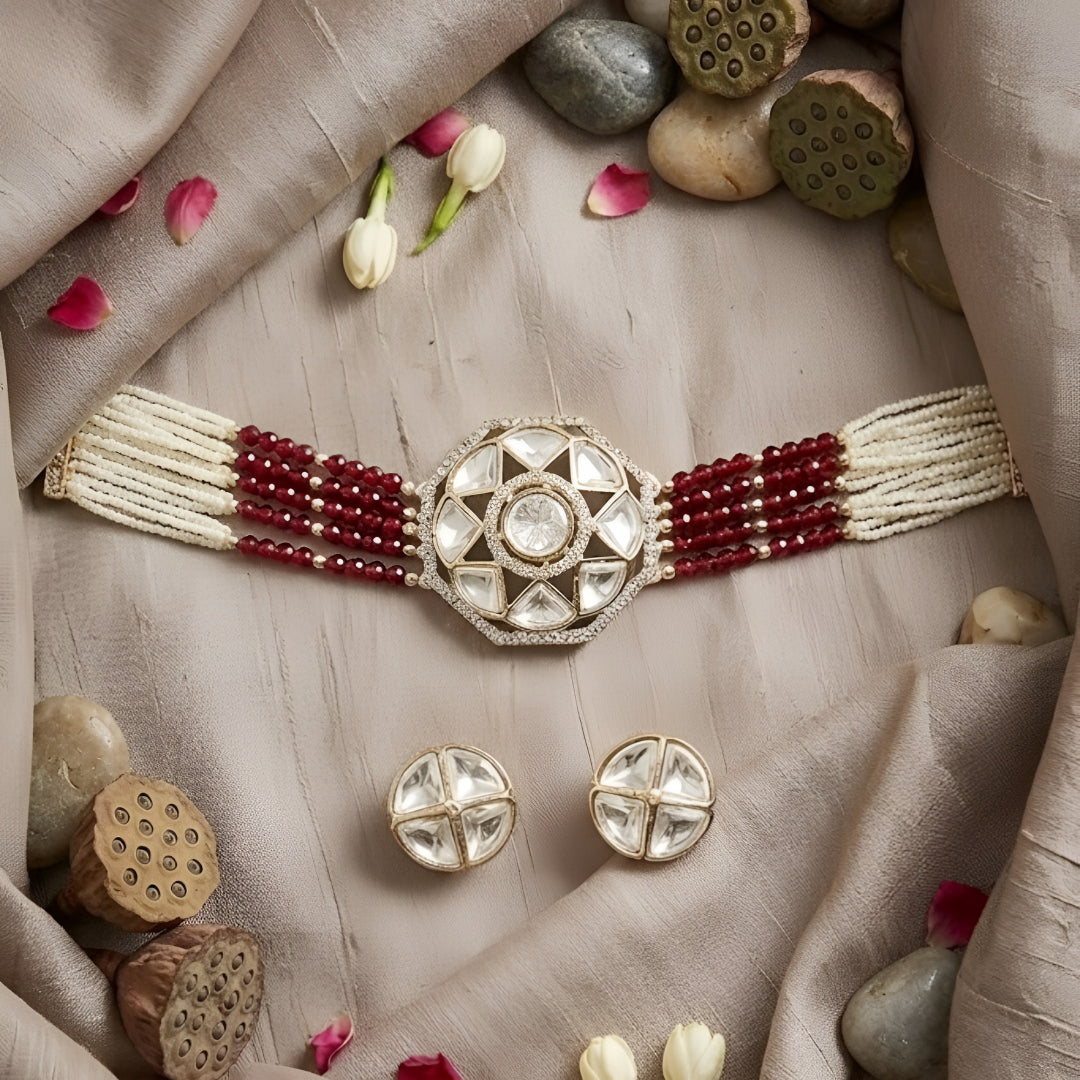 Handcrafted Kundan bracelet with red crystal bead strands and matching round stud earrings on a white background.