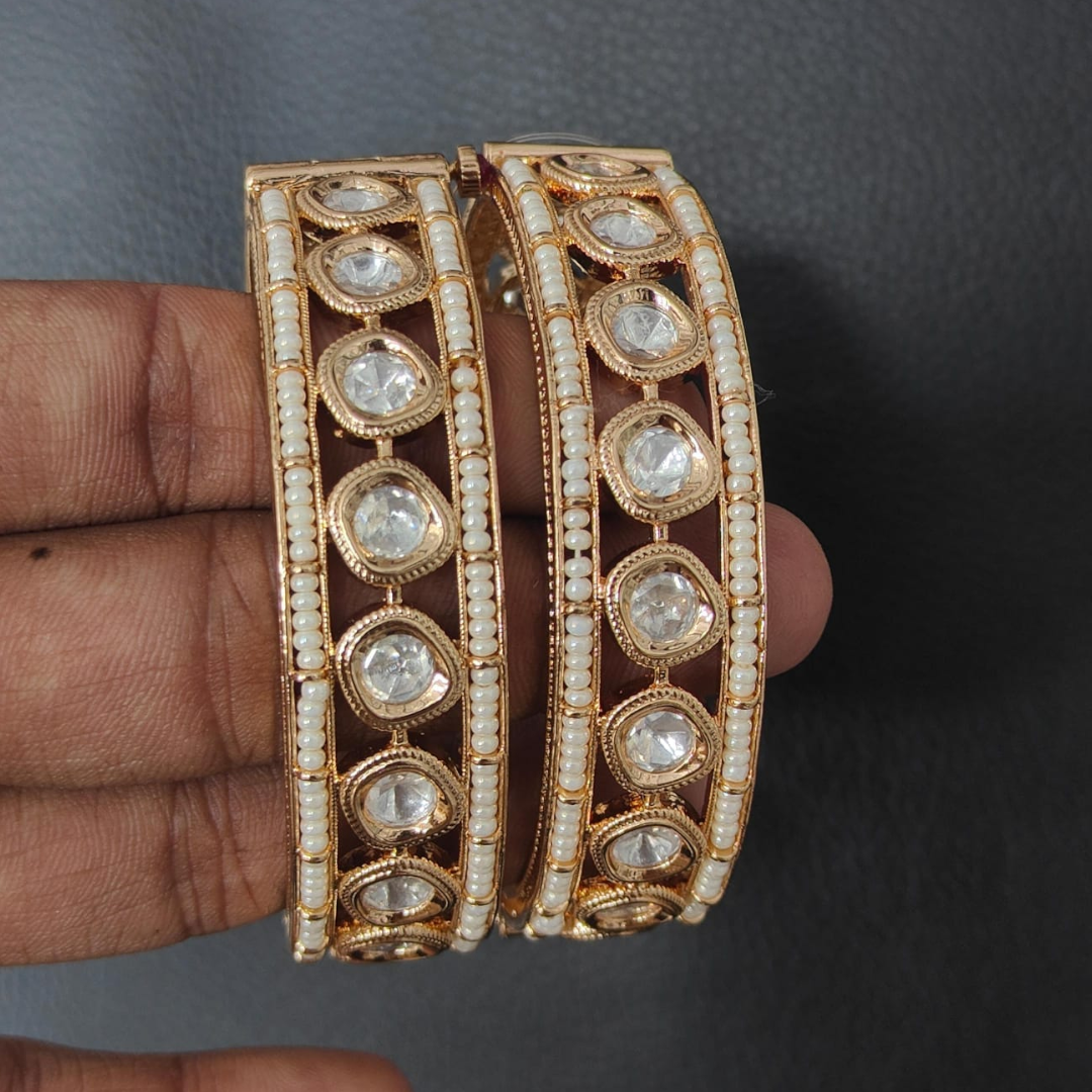 Gold-plated traditional bangles with Kundan stones and pearl embellishments for women