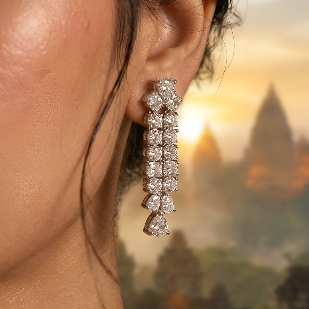 Silver-tone layered crystal necklace with matching drop earrings featuring sparkling clear stones in an elegant bridal jewelry design.