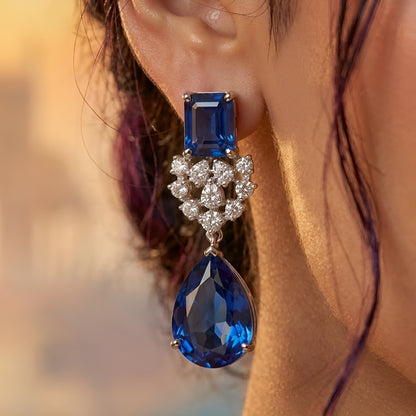 Elegant blue sapphire crystal choker necklace set with zircon-studded silver finish and matching drop earrings for women.