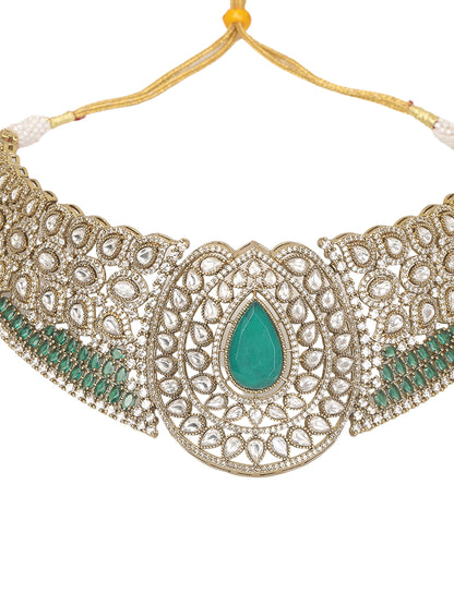 Gold-tone choker necklace set with intricate kundan-style detailing, highlighted by a large teardrop green stone centerpiece and matching drop earrings.