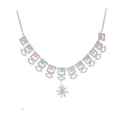 "Geometric pastel stone necklace and earring set displayed on a black velvet stand with floral centerpiece"