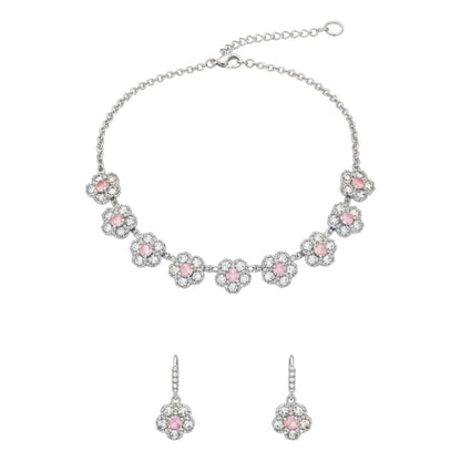 Silver floral necklace and matching earrings set with sparkling round crystals displayed on a red velvet jewelry stand, perfect for weddings and festive occasions.