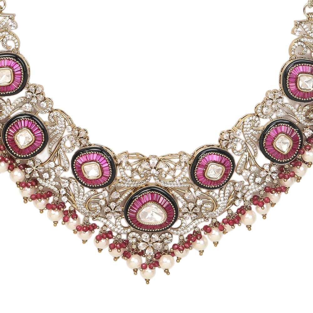Gold-tone traditional necklace set with pink kundan-style stones, intricate detailing, pearl bead drops, and matching ornate dangling earrings.