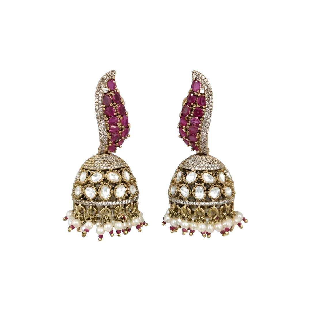 Antique gold Kundan jhumka earrings with ruby stones, sparkling American diamonds, and pearl drop fringe for women.