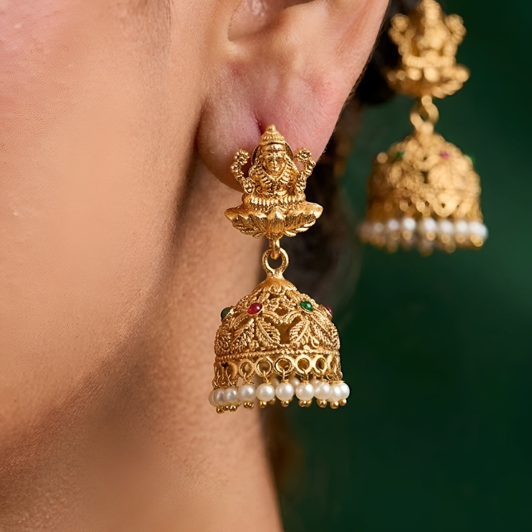 Traditional South Indian Temple Jewellery Lakshmi Necklace Set with matching Jhumka Earrings, antique gold finish, green bead drops, and ruby stone embellishments for bridal and festive wear.