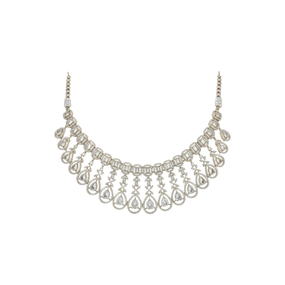 Gold plated bridal Kundan choker necklace set with teardrop earrings displayed on a red velvet stand.