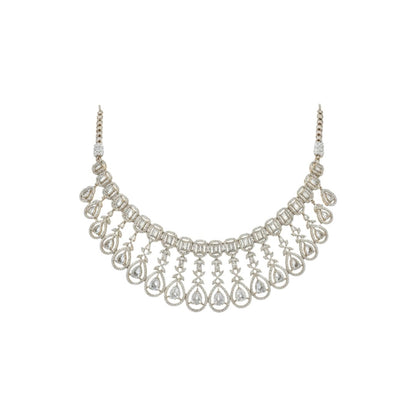 Gold plated bridal Kundan choker necklace set with teardrop earrings displayed on a red velvet stand.