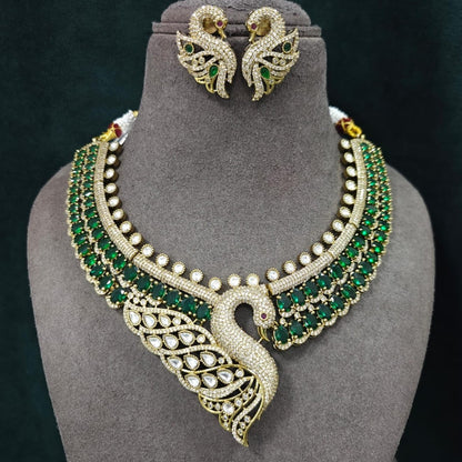 Luxury green swan designer necklace set with American diamonds, emerald green stones, and matching swan earrings for bridal wedding and party wear.