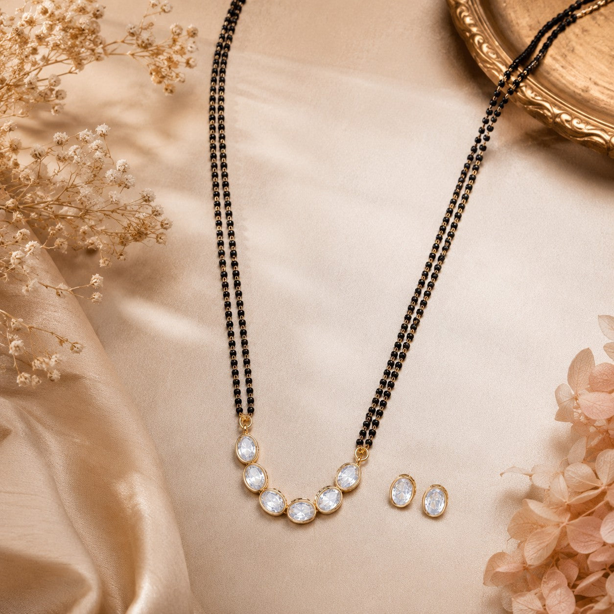 Elegant oval stone black beads mangalsutra necklace set with matching stud earrings for women in gold-tone finish