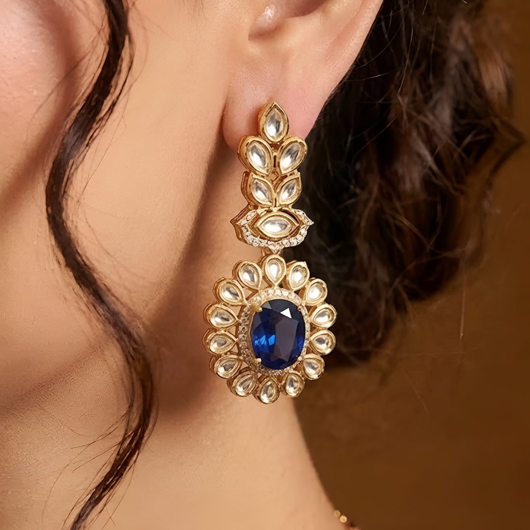 Gold-tone Kundan-inspired necklace and earrings set featuring white stones and deep purple oval gemstone accents in an elegant traditional design.