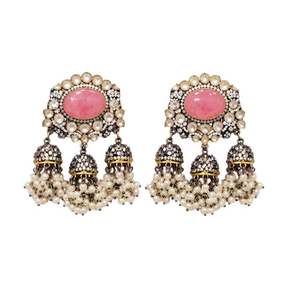 Pink Kundan jhumka earrings with antique gold finish, oval pink stone, sparkling Kundan crystals, and pearl tassel drops for bridal and festive wear.