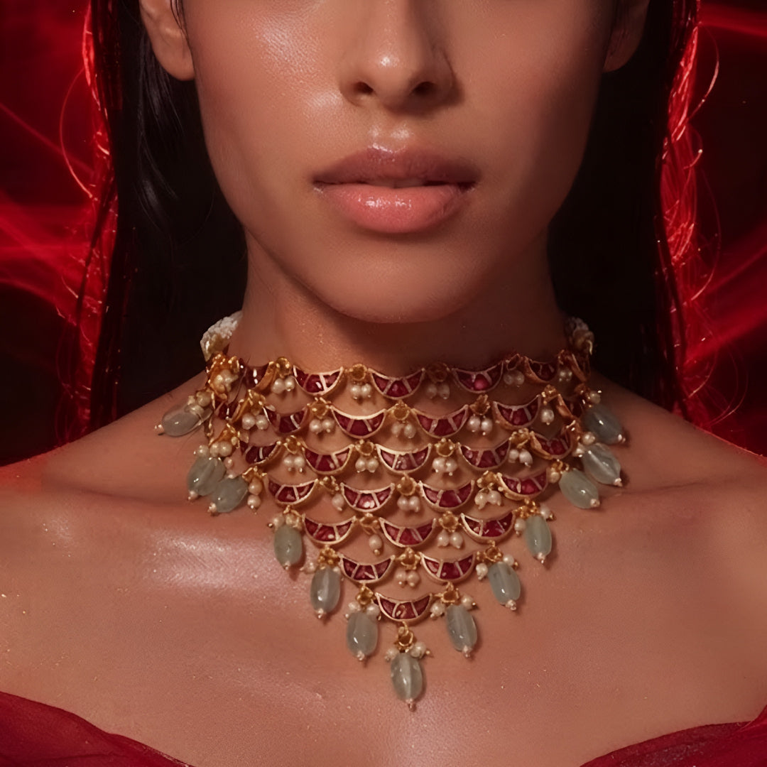 "Layered Kundan choker necklace and earring set in maroon gold with pearl and green bead drops, bridal jewellery styled on model"