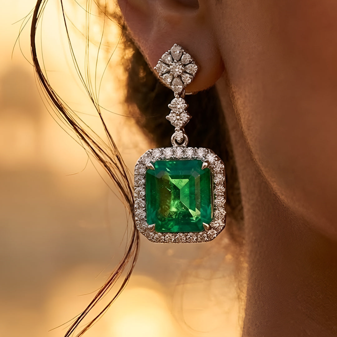 Elegant emerald green crystal pendant necklace set with sparkling zircon-studded chain and matching drop earrings in a gold-tone finish.