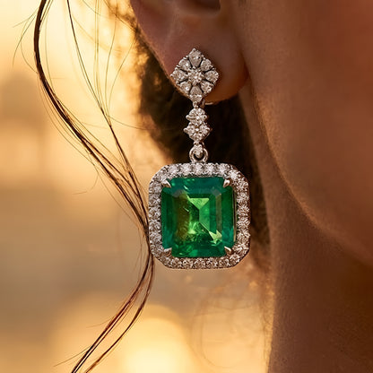 Elegant emerald green crystal pendant necklace set with sparkling zircon-studded chain and matching drop earrings in a gold-tone finish.