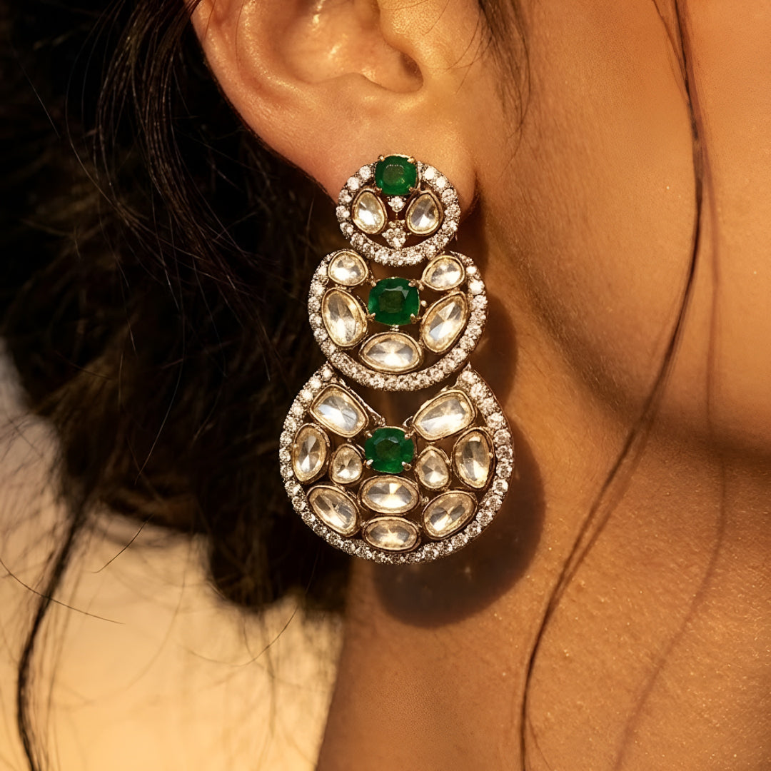 Luxury Kundan Polki necklace set with matching earrings featuring uncut Polki diamonds, green emerald accents, and traditional bridal jewelry craftsmanship in a gold finish.