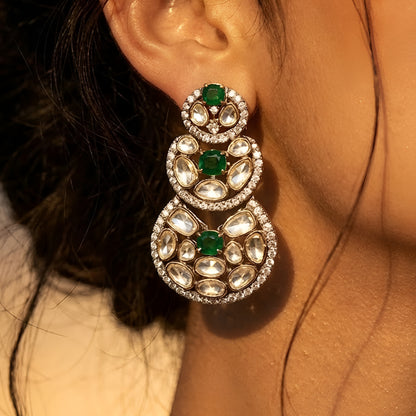 Luxury Kundan Polki necklace set with matching earrings featuring uncut Polki diamonds, green emerald accents, and traditional bridal jewelry craftsmanship in a gold finish.
